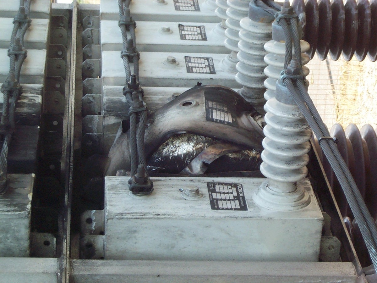 A high power capacitor after failure, its case split open