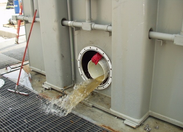 A bucket tipped through the hatch, throwing oily water across the walkway grating.